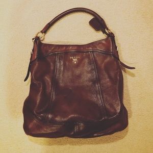 PRADA Cervo Antik flat hobo bag in Cacao Brown.